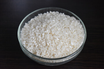 Plate with rice side view. Rice porridge in glass bowl isolated on black background with clipping path, side view