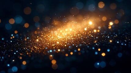 Obraz premium Sparkling particles in gold and blue swirl gracefully, evoking a sense of wonder and enchantment