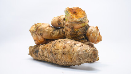 A close-up image of fresh Java turmeric (Curcuma xanthorrhiza) rhizomes or temulawak placed on a white background