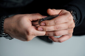 An Intense Moment of Focus: Hands Holding a Close-Cutting Knife