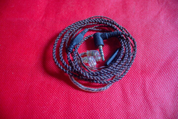An In Ear Monitoring cable is photographed on a plain red cloth.
Pinrang, South Sulawesi Indonesia.
November 17 2024