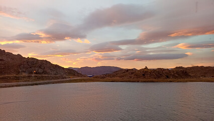 A beautiful sunset over a lake in Honningsvag on Mageroya Island, Norway