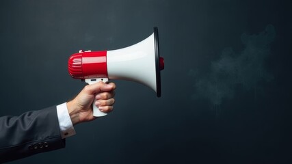 Hand holding red and white megaphone on background with free space for text