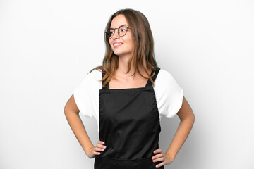 Fototapeta premium Young caucasian restaurant waiter woman isolated on white background posing with arms at hip and smiling
