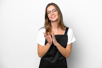 Young caucasian restaurant waiter woman isolated on white background applauding after presentation in a conference