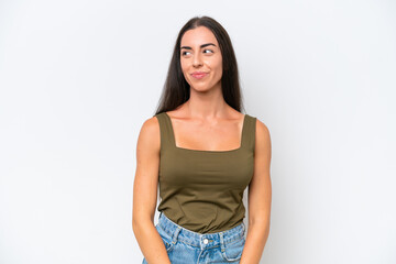 Obraz premium Young caucasian woman isolated on white background making doubts gesture looking side