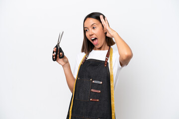 Young seamstress woman isolated on white background doing surprise gesture while looking to the side