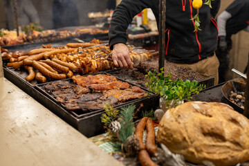 Grilled sausages in street market in a medieval fair in Poland. Sausages and pork ready to eat....