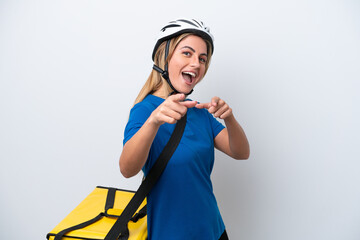 Young caucasian woman with thermal backpack isolated on white background pointing to the front and smiling