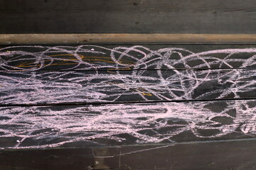 Children's chalk drawings on the sidewalk in the city.