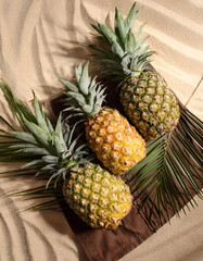 pineapples arranged on a cloth mat in the sand