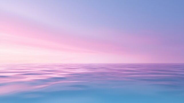 A beautiful blue ocean with a pink sky in the background