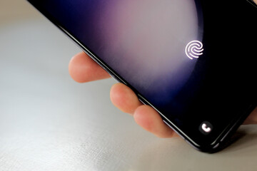 phone in hand isolated on a white background with biometric verification for identity