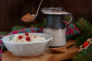 Traditional Scandinavian-style rice porridge, pudding in Christmas style with decoration, close up, top view