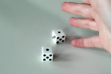 Hand throwing pair of dice game metaphor life unpredictability probability statistics chance...