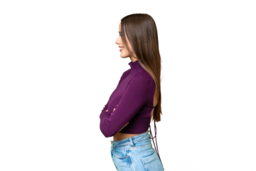 Young beautiful woman over isolated chroma key background in lateral position