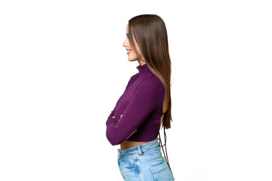 Young beautiful woman over isolated chroma key background in lateral position