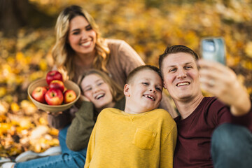 Father Taking Photos Of Family On Picnic
