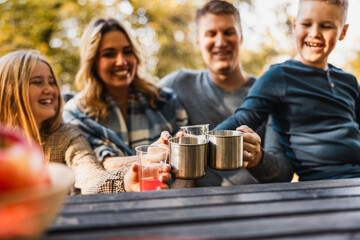 Family Drinking Tee In Park