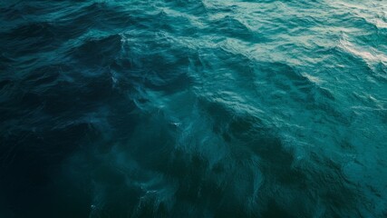 Obraz premium Ocean's Embrace: Capturing the serene vastness of the ocean, the image unveils a tapestry of turquoise and deep blue, illustrating the endless dance of waves under the sky.