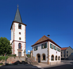 Obraz premium Gothic church tower and small town hall in Ottersheim bei Landau, Rheinland-Pfalz region in Germany