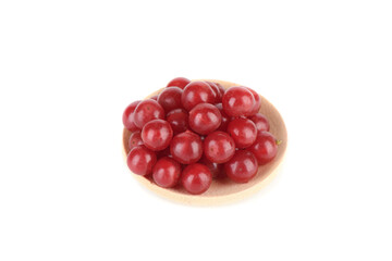 A bunch of ripe viburnum berries on a wooden serving plate over white background.