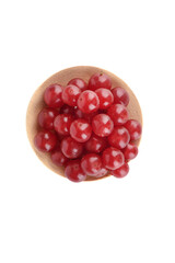 Top view of a pile of ripe viburnum berries on a wooden serving plate over white background.