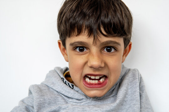 Young child showing excitement about losing a baby tooth