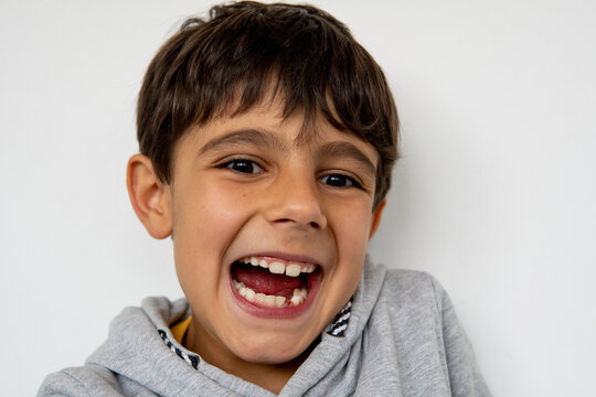 Joyful child celebrating first lost tooth and waiting for the Tooth Fairy