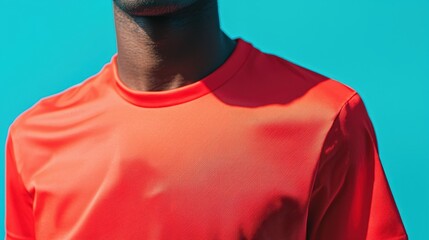Close-up Portrait of Male Athlete in Vibrant Red Sports Shirt Against Bright Turquoise Background, Showcasing Confidence and Energy for Fitness and Sports Themes
