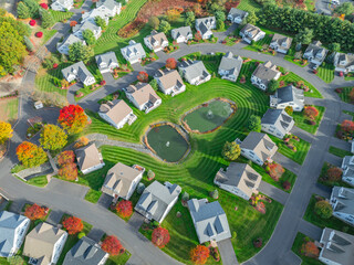 aerial drone view of neighborhood street with single family homes