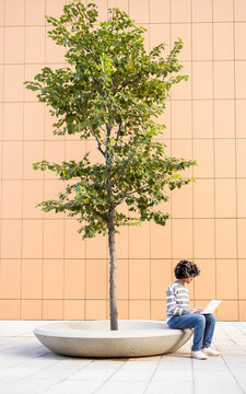 Mixed Race Woman with Vitiligo Studying Outdoors on Campus