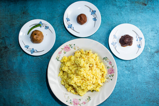 Yellow Moong Dal Khichdi with Alu bhorta served in plate isolated on grey background top view of bangladeshi food