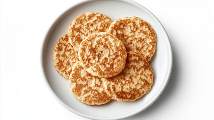 Golden brown pancakes served on a white plate