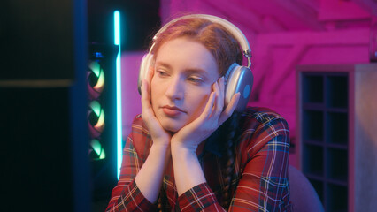 Tired exhausted girl Caucasian woman late online cyber gaming addict dark neon studio female bored...