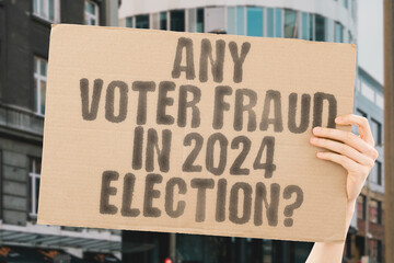 The phrase 'Any voter fraud in 2024 election?' on a banner in a person's hand. Human holds a cardboard with an inscription. Democracy. Integrity. Trust. Voting. Government. Rights. Justice