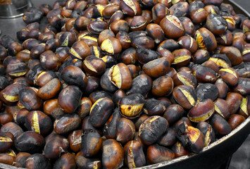 roasted chestnuts typical autumn street food for sale at the food stall in the city park