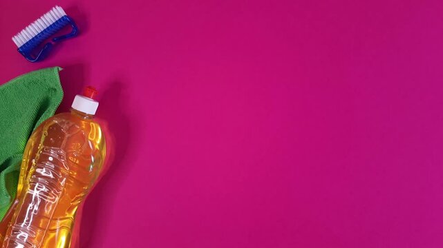 Stop motion with set of kitchen cleaning items appear and disappear one by one on pink background. Housecleaning concept looped video.