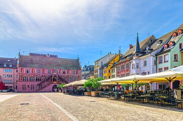 Mulhouse cityscape, Hotel de Ville Town hall, typical colorful buildings and street restaurant on...