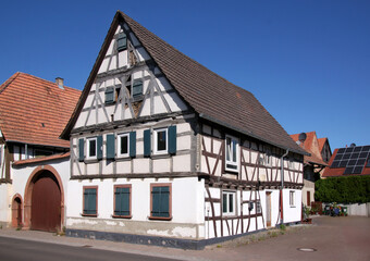 A half-timbered wooden residential house in need of renovation in the old village of Herxheim bei Landau, Pfalz region in Germany