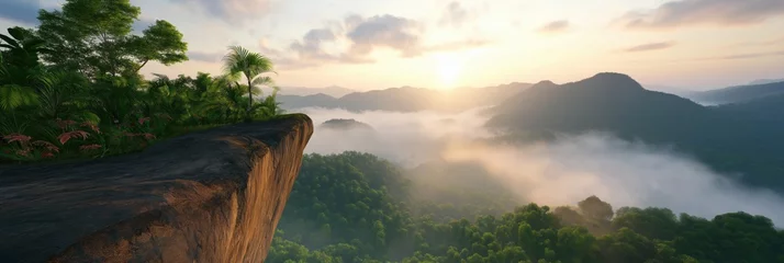 Foto op Canvas A mountain range with a foggy sky and a sun setting in the background. The scene is serene and peaceful, with the sun casting a warm glow over the landscape © Andrii Zastrozhnov