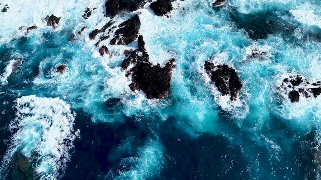 Atlantic ocean waves, rocks, cliffs, waves and turquoise water in Atlantic ocean, Mosteiros, Azores islands. Aerial 4K drone video footage of Acores archipelago