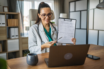 woman doctor hold clipboard and show them on video call