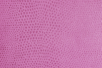 Cloth structure of jacquard pink fabric with abstract shabby spotted embossed texture closeup, macro. Upholstery, decorative cloth structure, home decor canvas. Background, backdrop, wallpaper.