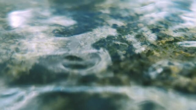 static close-up of rolling waves on a smooth stone in slow motion