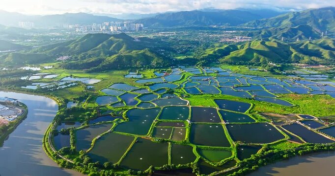 Mountains with river and fish ponds landscape at sunrise in Hong Kong