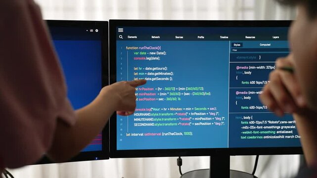Slow motion back end software developer engineer for computer programming working together on debugging writing computing code, solving complex algorithms display on monitor in office. Burgeoning