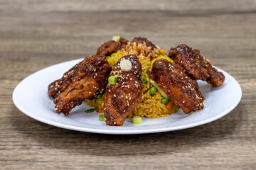 Generous scoop of Vietnamese fried rice with delicious chicken wings arranged with perfect presentation