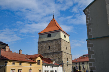 Obraz premium A stone belfry from the eighteenth century stands next to the co-cathedral of the Nativity of the Blessed Virgin Mar