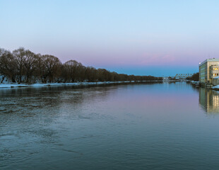 A calm river with a beautiful blue sky in the background